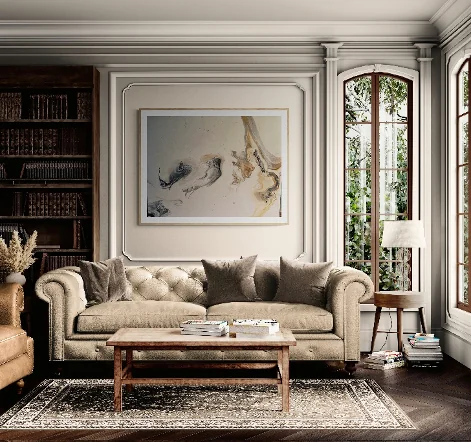 A neutral abstract pour painting by Elizabeth Zab framed above a sofa in a styled living room